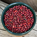organic aduki beans in a bowl sitting on a log