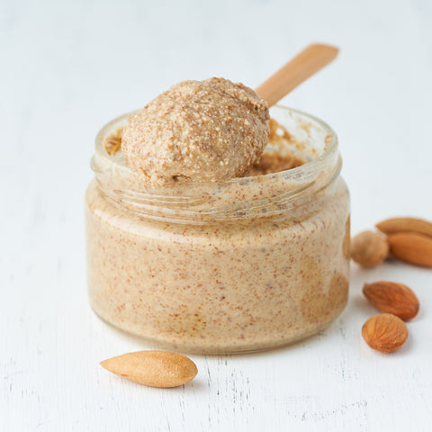 organic almond butter in clear glass jar