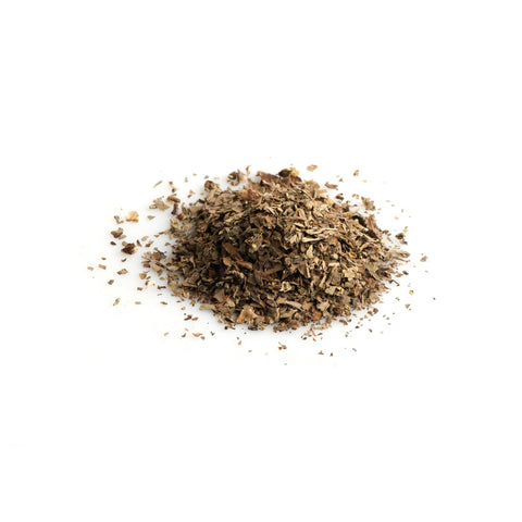 Loose organic dried basil leaves on white background