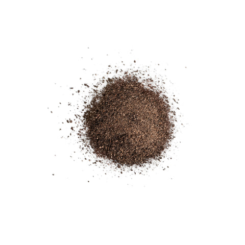 Organic ground black pepper medium grind on white background