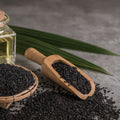 organic black seeds in a wooden scoop and basket 