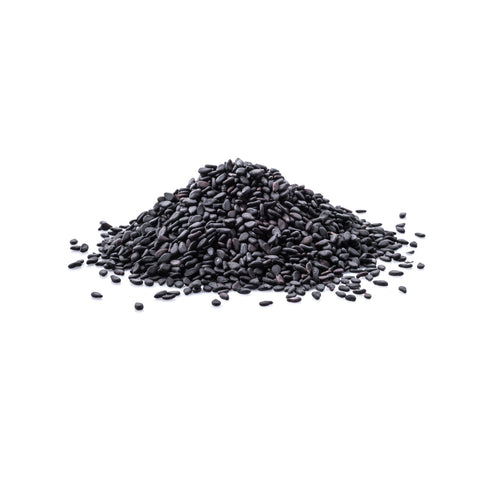 Organic black sesame seeds with shell on a white background