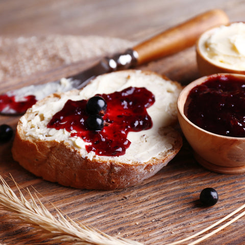 Organic blackberry fruit spread on a piece of bread