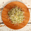 organic broccoli sprouts on a wooden plate