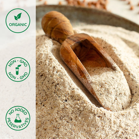 Wooden scoop in a pile of organic  buckwheat flour