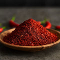 Organic ground cayenne pepper in a wooden bowl 