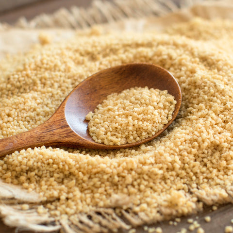 Spoonful of organic couscous granules made from durum wheat