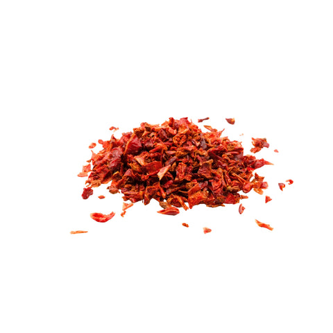 Organic diced red bell pepper on a white background