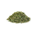 Dried organic parsley flakes on a white background