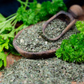 Scoop of dried organic parsley flakes