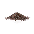 Organic black forbidden rice grains, uncooked on a white background