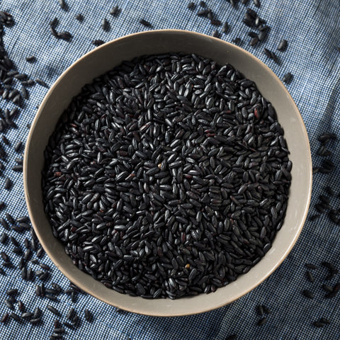 Bowl of uncooked organic black forbidden rice grains
