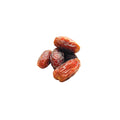 Organic halawi dates on a white background