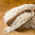 Scoop of organic long grain white rice grains