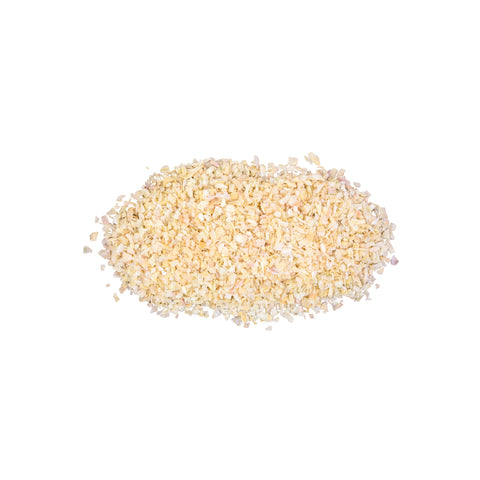 Dried minced organic onion flakes on white background