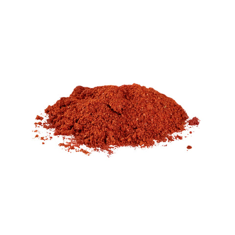 Ground organic paprika on white background