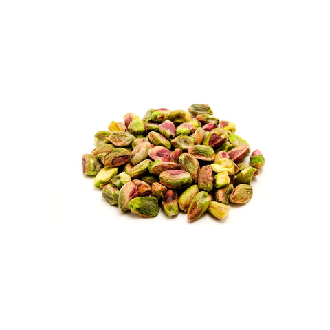 Organic raw pistachio meats unshelled on a white background