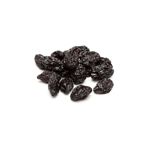 Organic pitted prunes with rich, glossy texture on white background