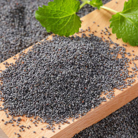 Organic whole poppy seeds on a table