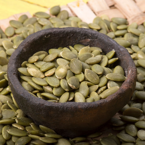Bowl of raw organic hulled pumpkin seeds