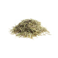 Whole organic dried rosemary leaves on a white background