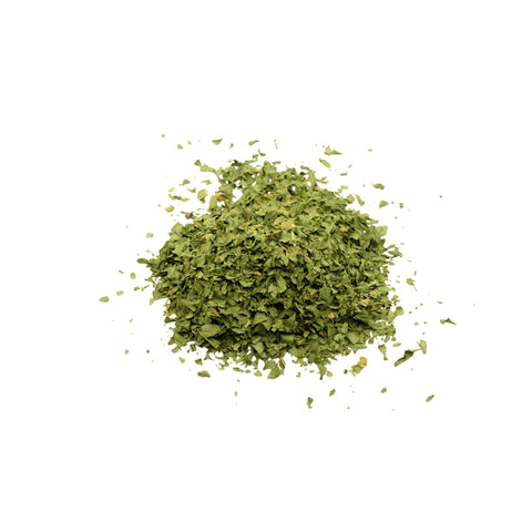 Organic spinach flakes on white background