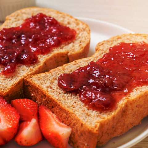 Organic strawberry fruit spread on a piece of bread