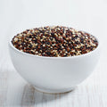 Bowl of organic white, red and black quinoa