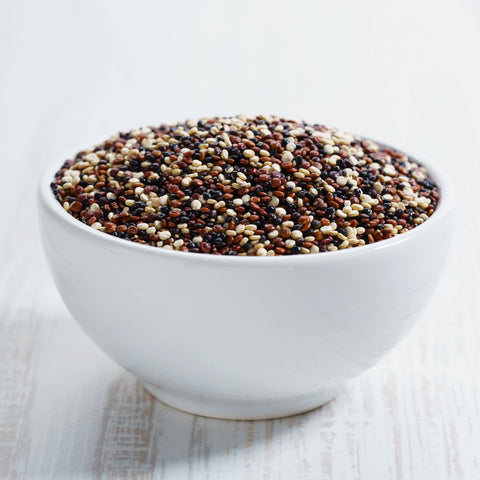 Bowl of organic white, red and black quinoa