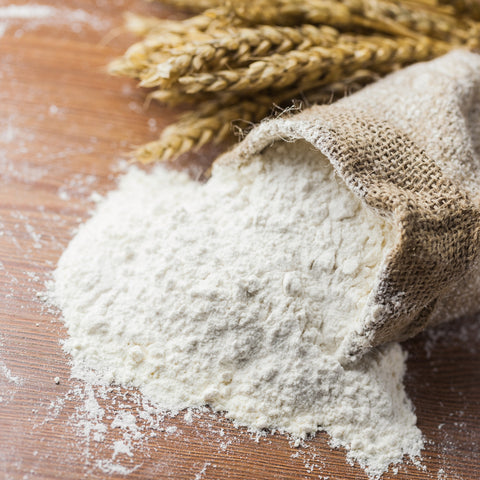 Organic unbleached wheat flour poured on a table