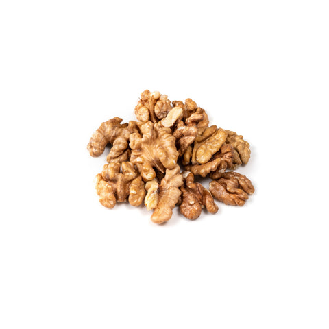 Shelled organic raw walnuts on white background
